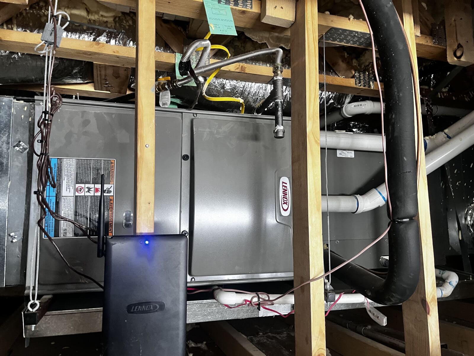 Lennox communicating control equipment mounted beside an attic air handler
