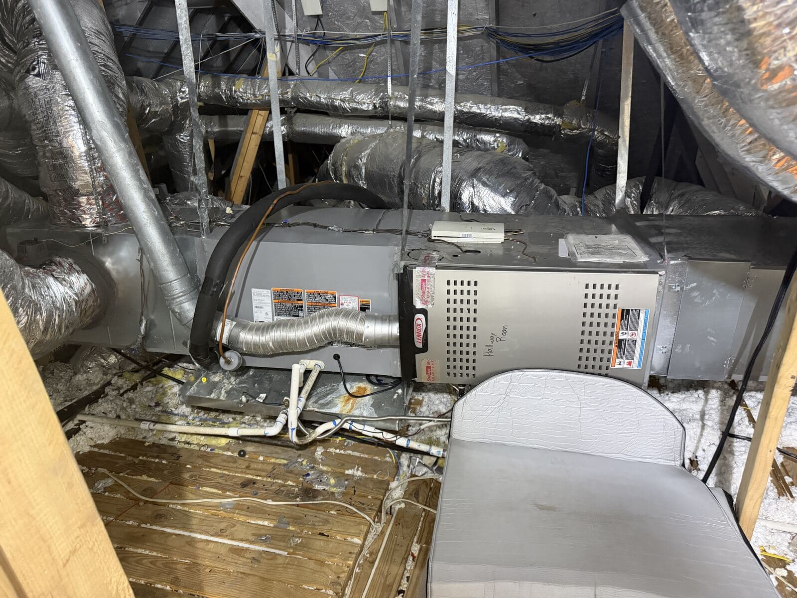 Attic furnace in a tight-clearance Dallas attic where after-hours no-cool calls end up