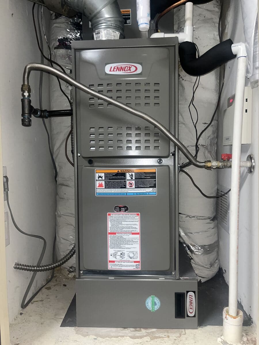 Lennox gas furnace installed in an interior utility closet with new gas connector and venting