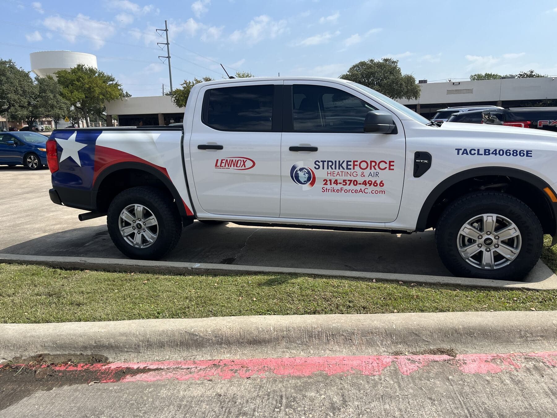 Strike Force Heating & Air service truck with Texas flag wrap and the (214) 570-4966 phone number